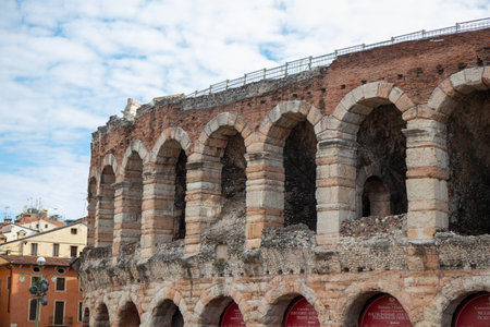 Exterior walls of the Arena di Verona, Italy - a well-preserved Roman amphitheater with massive stone construction, arches, and historic significance in the heart of the cityの写真素材
