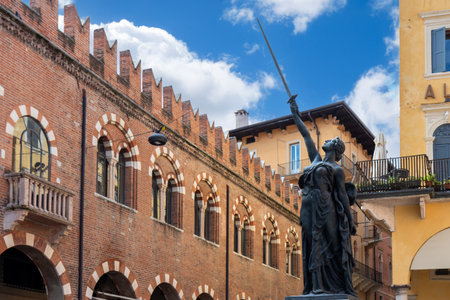 Bronze sculpture La Civilta Italica, Italic Civilization in Piazza delle Erbe, Verona, Italy - an iconic artwork celebrating Italian culture and heritage, surrounded by medieval buildings and historic landmarksの写真素材