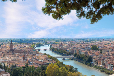 Aerial view of Verona, Italy, showing the historic city along the Adige River with red brick roofs,...