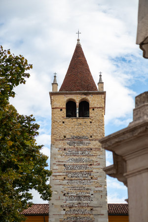Bell tower of the Santi Apostoli church in Verona, Italy - a historic structure rising above the city with classic stone architecture and a prominent tower visible from surrounding streetsの写真素材