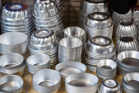 Assortment of new aluminum egg tart molds, food-grade, reusable, fluted design for easy release, ideal for mini tarts, quiches, cupcakes, puddings, and cheesecakesの写真素材