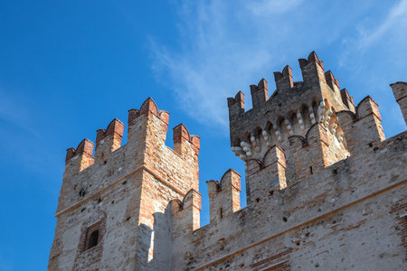 Towers and walls of Scaliger Castle Castello Scaligero in Sirmione, Italy, a historic lake fortress from the Scaliger era, gateway to the medieval town center on Lake Gardaの写真素材