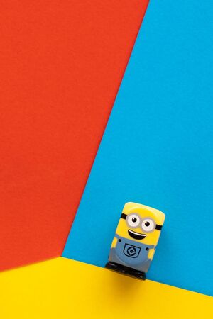 Milan, Italy - August 11 2019: Minion toy happy minifigure construction worker. Creative minimalistic design, flat lay.のeditorial素材