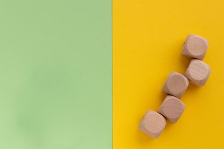 Kids toys on pastel yellow green paper background. Top view on children's educational games. Wooden...