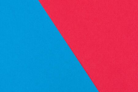 Red blue paper background. Geometric figures, shapes. Abstract geometric flat composition. Empty space on monochrome cardboard. Card board background. Diagonal directionの写真素材