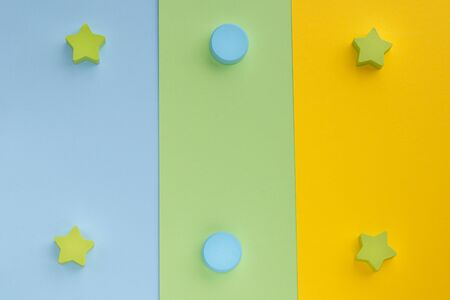 Kids toys on pastel blue green paper background. Top view on children's educational games. Wooden stars and circles. Flat lay, copy space.の写真素材