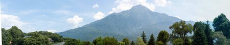 Fantastic view of mountains and trees on a sunny summer day. District of Como Lake, Colico, Italy,...