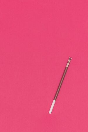 Pencil on red paper background. Top viewの写真素材
