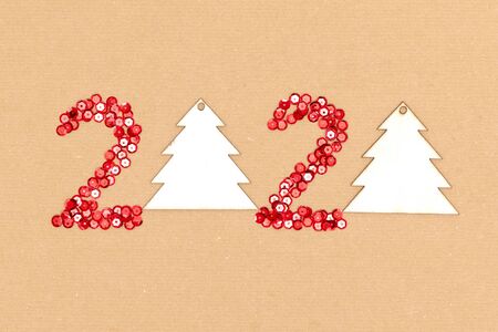 2020 made of red sparkles and decorative christmas toys on craft sheet of paper. Happy new year 2020 conceptの写真素材