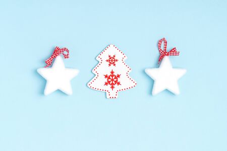 New Year and Christmas composition from white stars, chrismas tree on pastel blue paper background. Top view, flat lay, copy spaceの写真素材