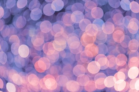 Abstract Christmas and New Year background with blur bokeh effect, holiday backdrop. Glitter rainbow Christmas festive lightsの写真素材