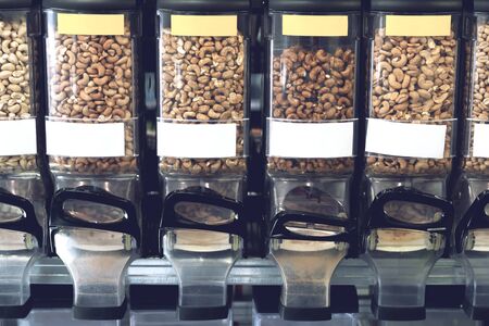 Dispensers with nuts in zero waste shop. New trend alternative buying. Concept healthy food...