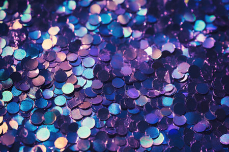 Blue and purple sequins that create dazzling background, round and shiny, reflecting the light in different colors. Magic, fantasy and wonder atmosphere, glittering art.の素材