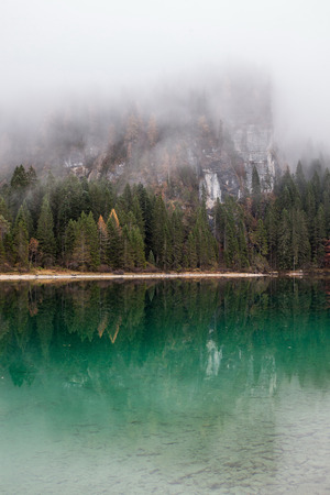 alpine lake in foggy morning in mountainsの写真素材