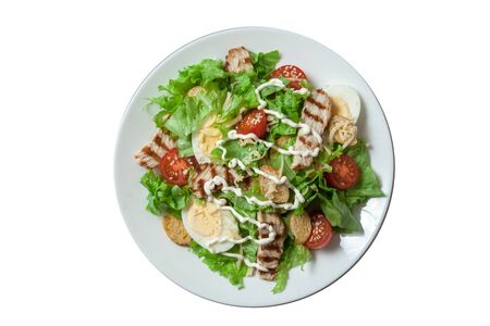 Caesar salad with grill chicken fillet isolated on white backgroundの写真素材