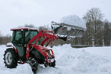 Tractor cleaning snow in a parkの写真素材