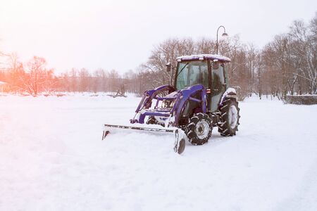 Tractor cleaning snow in a parkの写真素材