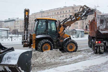 Tractor cleaning snow in a parkの写真素材