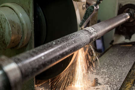 Professional workers are doing the milling process for metal parts, metal machinery in large...