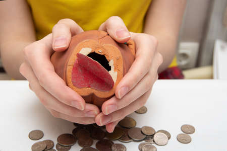 Saving money. Need open piggy bank with coins, scattered coins of different countries, on a white...