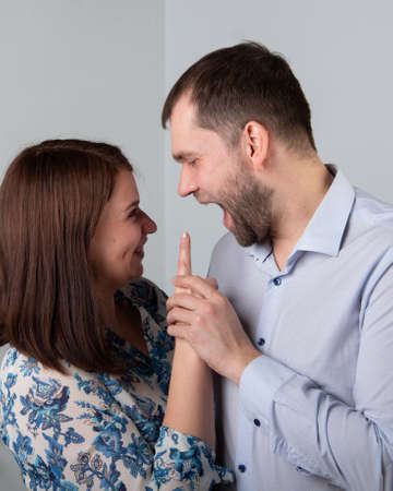Angry husband yells at his wife. A woman threatens with a forefinger to a man. Unhappy married couple, relationship concept.の写真素材