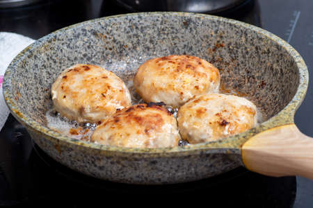 The process of cooking in a pan with fried meat, meatballs, barbecue. Fast Food concept - closeup of cutlets.の写真素材