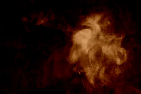 Orange smoke isolated on a black background. smoke image is like a ghost. Mystic.の写真素材
