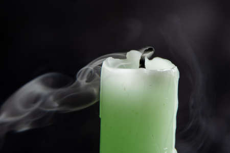 Smoke from a candle on a black isolated background. An interesting and weird smoke pattern, close-up, abstraction.の写真素材