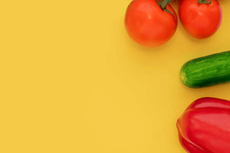 Tomato, cucumber, pepper on a bright yellow background, top view, Flat lay, copy space. Healthy eating concept, Slim.の写真素材