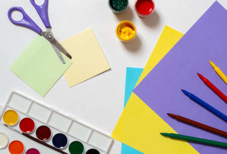 Stationery for study at school lies on blue. Back to school. Books and textbook, apple material for...