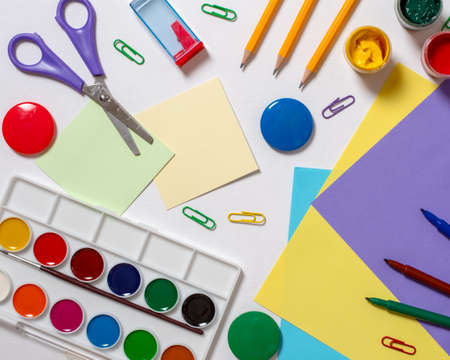 Stationery for study at school lies on blue. Back to school. Books and textbook, apple material for...
