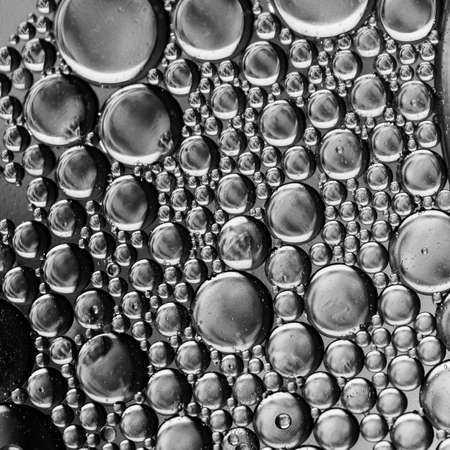 Close up oil bubbles with black and white background, macro image, blurry water droplets, abstract wallpaper background.の写真素材