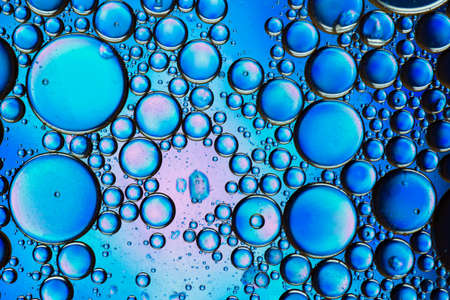 Abstract colorful bubbles. Mixing water and oil. Unrealistic colored blue bubbles. Can be used as a festive background, postcard texture.の写真素材