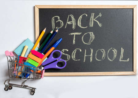 Creative flat top view back to school concept, shopping for school. Colored school supplies in a...