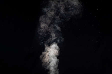Figured smoke on a dark background. Abstract background, design element, for overlay on pictures.
