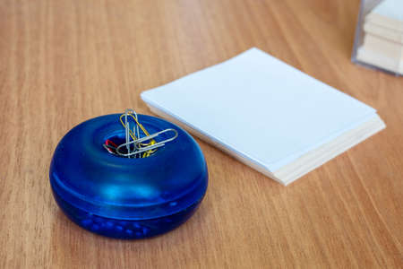 Workspace with blank paper and paper clips on a wooden table, copy space, top view. Business, school...