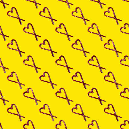 Seamless pattern heart shape with Christmas candies on a yellow background, top view, minimalism....