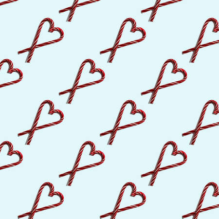 Seamless heart shape with Christmas candies on a light blue pastel background, top view. Can be used as decorative elements for Christmas and New Years, Valentine's Dayの写真素材