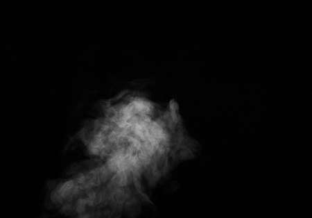 Smoke fragments on a black background. Abstract background, design element, for overlay on pictures.の写真素材