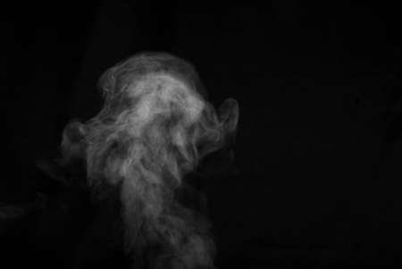 White smoke on black background. Abstract background, design element, for overlay on pictures.の写真素材