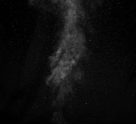 White smoke on black background. Abstract background, design element, for overlay on pictures.の写真素材