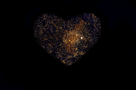 Colorful fireworks in the shape of a heart isolated on a dark background, close up, copy space. Can be used as a festive background for Valentines Dayの写真素材