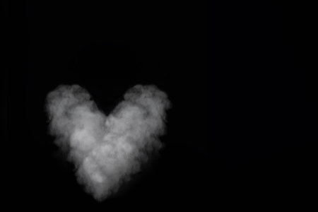 White smoke heart shape isolated on black background. Curly smoke for Valentines Day on a dark background. Abstract background, design elementの写真素材