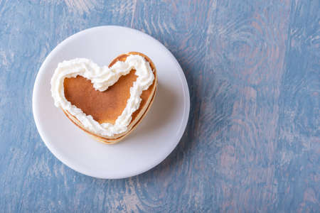 Valentines day creative breakfast. Romantic breakfast in bed. Homemade heart shaped pancake...