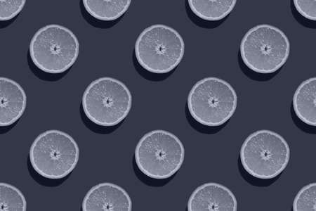 Seamless pattern of toned half of an orange isolated on a blue background, mock up, top view....
