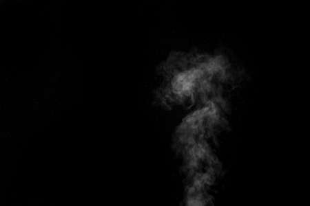 White smoke on black background. Figured smoke on a dark background. Abstract background, design element, for overlay on picturesの写真素材