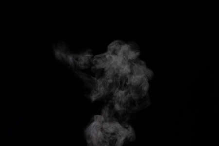 Figured smoke on a dark background. Abstract background, design element, for overlay on pictures.の写真素材
