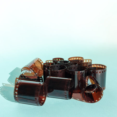 Used 35mm film rolls on blue background, copy space