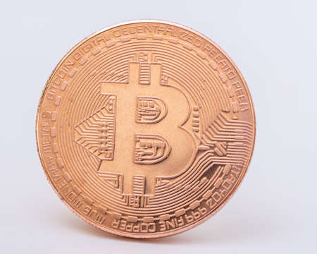 Gold bitcoin coin on a white background close-up. Physical bit coins. Digital currency....