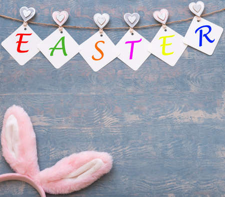 Easter colorful card made of garland with EASTER inscription and Easter pink bunny earsの写真素材
